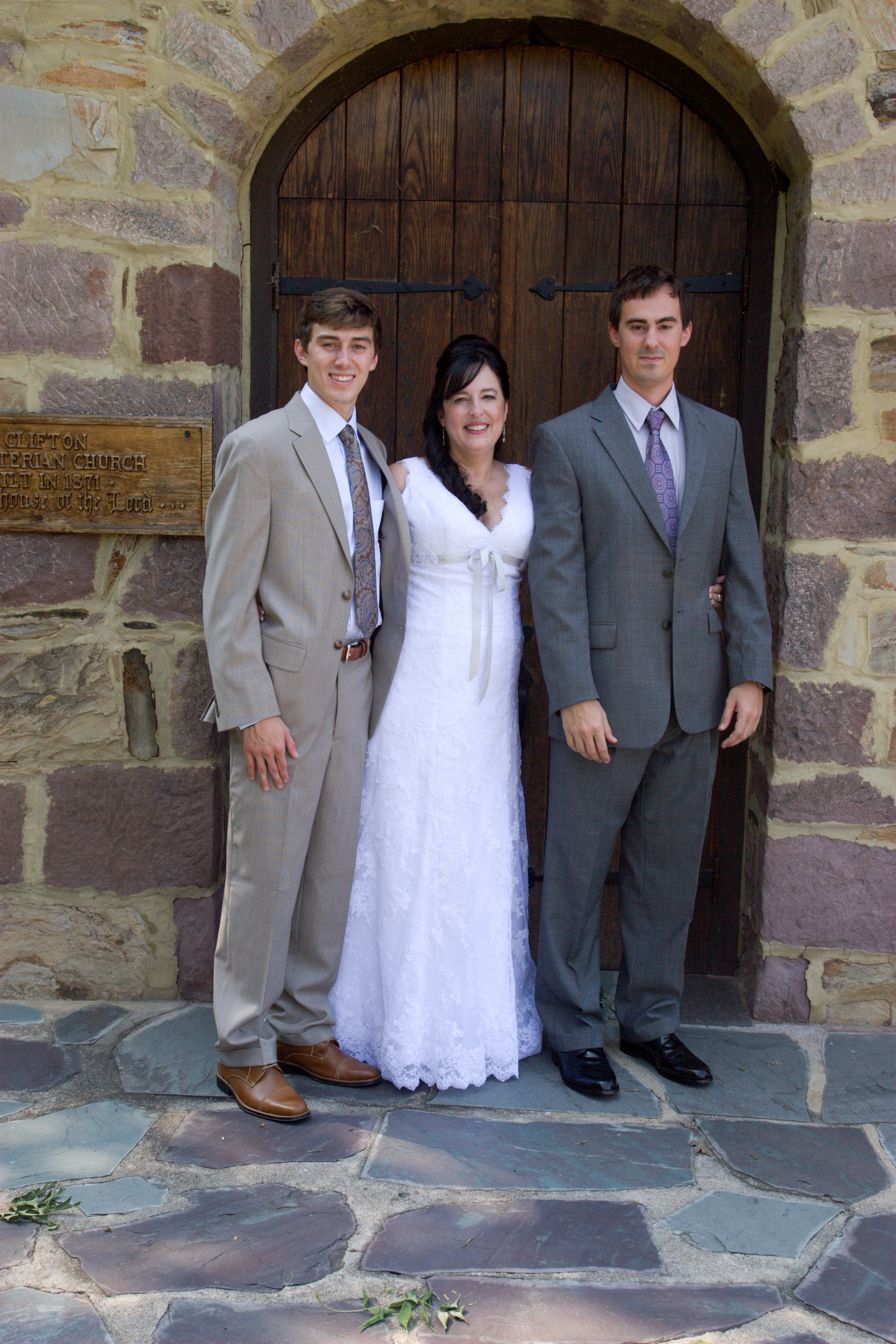 Bride and brothers at church door