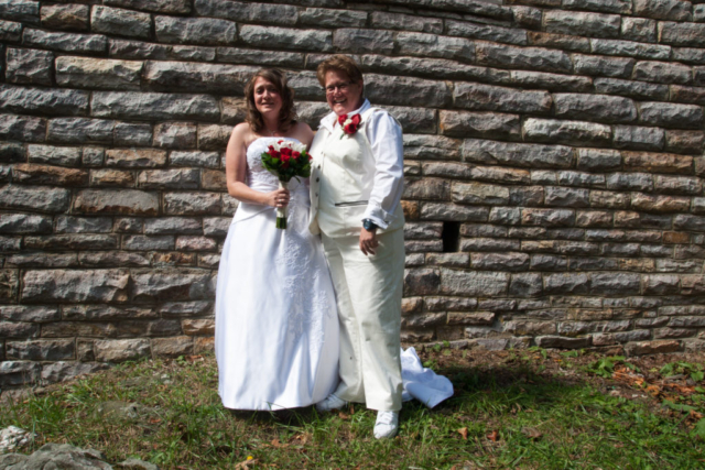 Couple with stone wall background