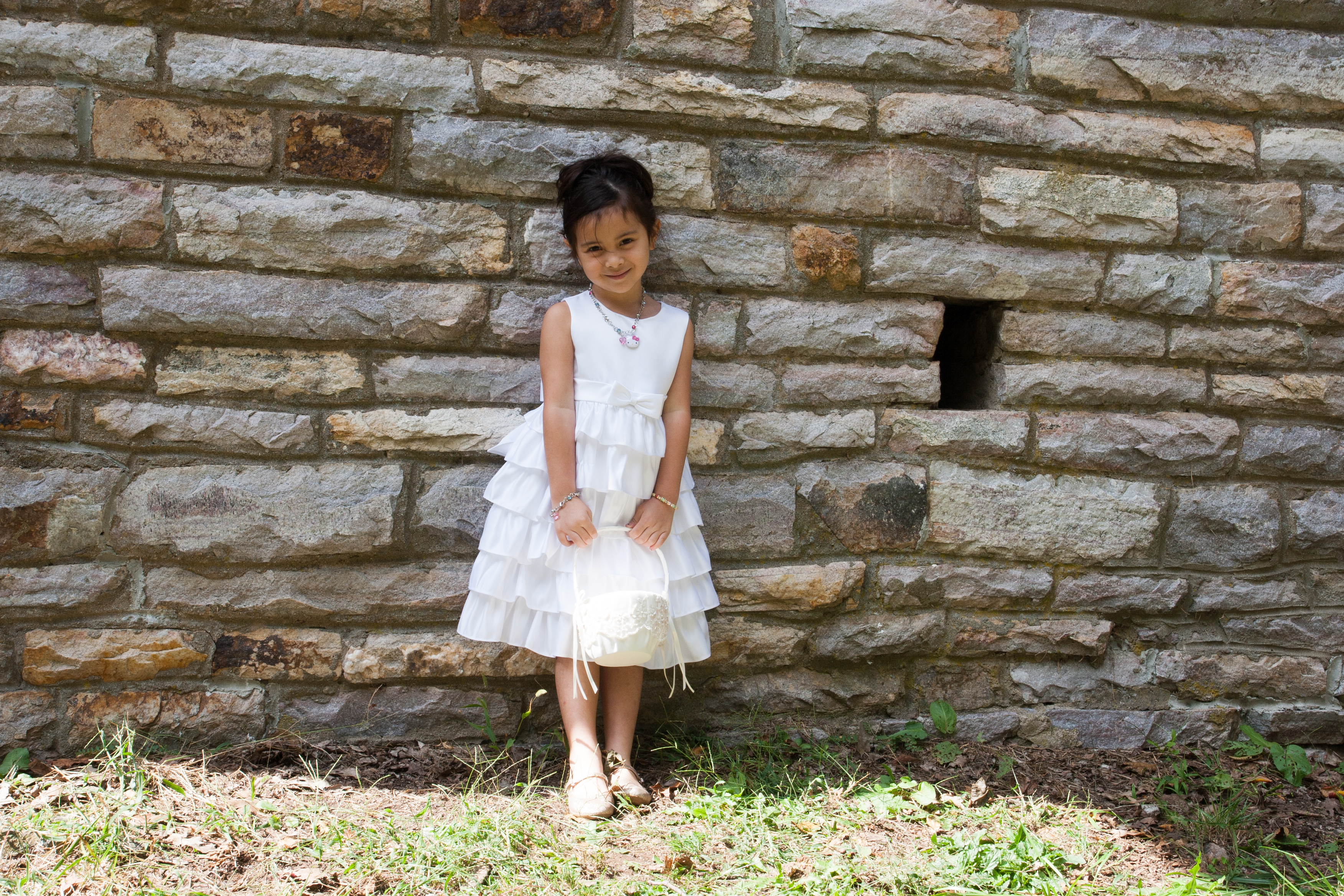 Flower girl against stone wall