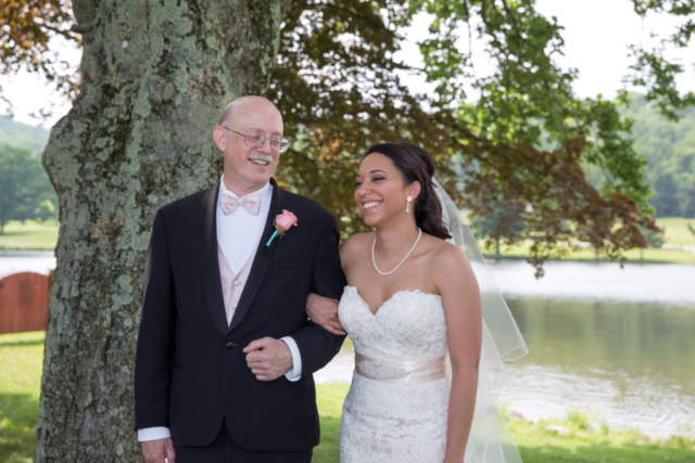 Bride and father laughing