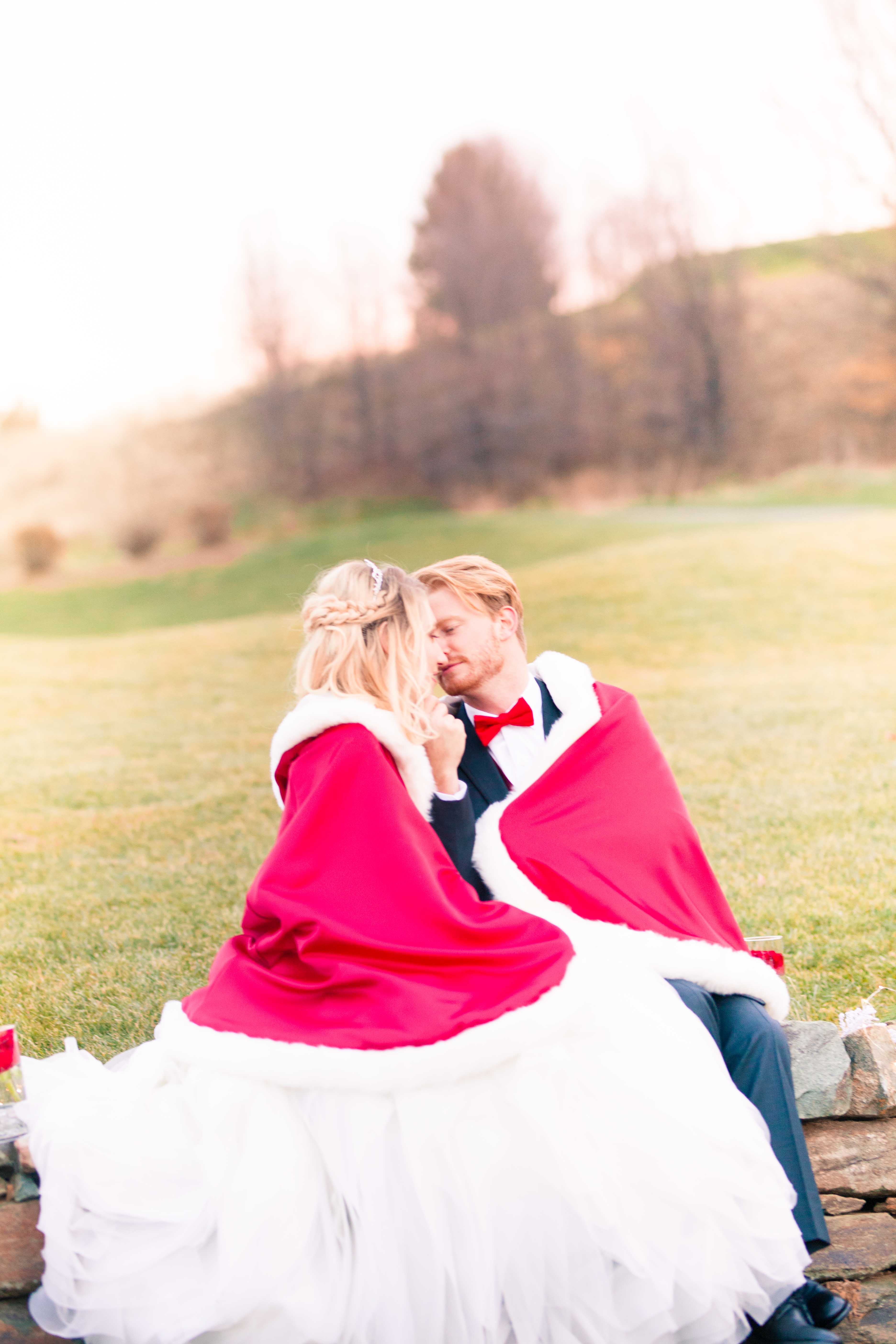 winter wedding couple in red capes