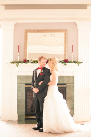 winter wedding couple in front of fireplace