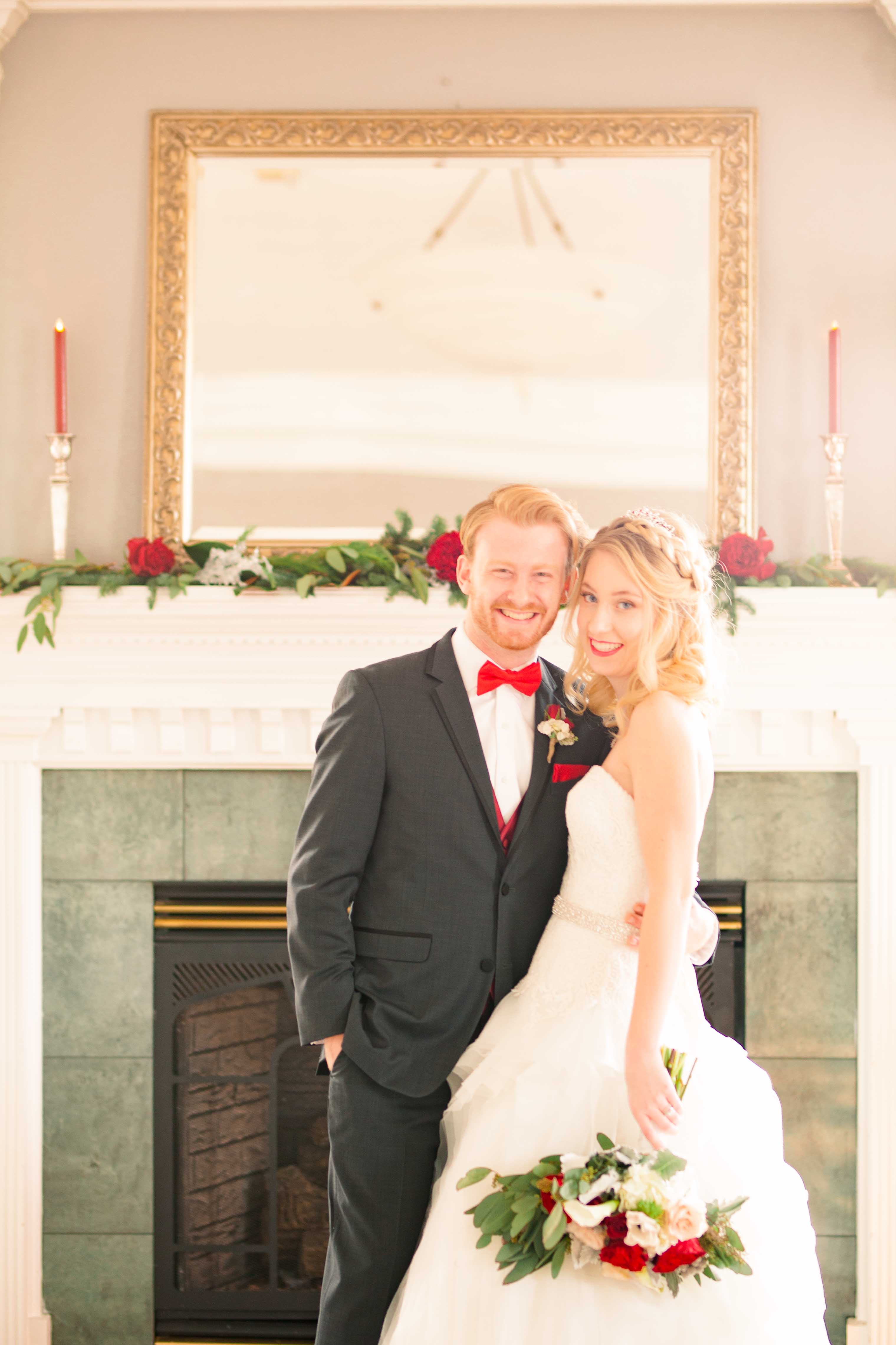 bride and groom in front of fireplace
